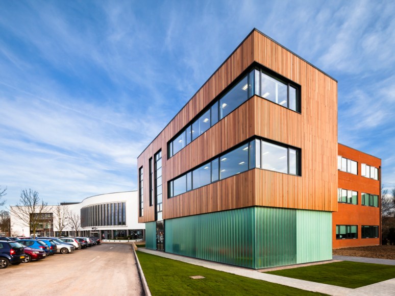 Side view of building showing adjoining structure in the background