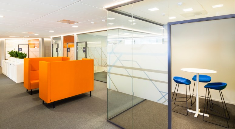 Effective use of High backed orange sofa for informal meetings.