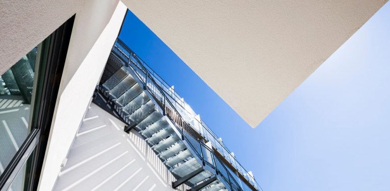 Graphic detail looking up at communal stairs to playground.