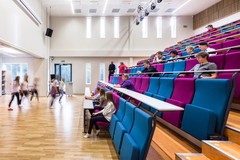 The auditorium with students dancing, at Nore Neset Skole, designed by Ramboll.