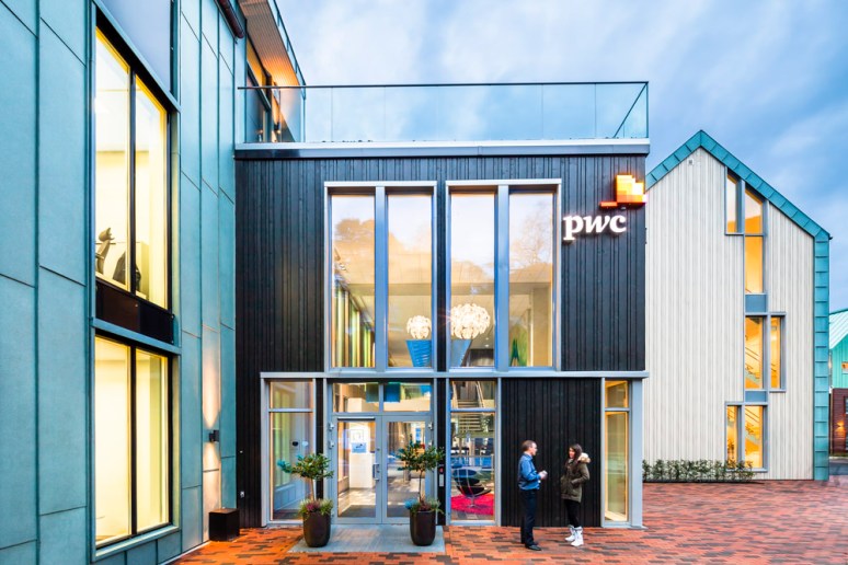 Employees outside the entrance of Price Waterhouse Coopers HQ designed by Ramboll, Bergen, Norway.