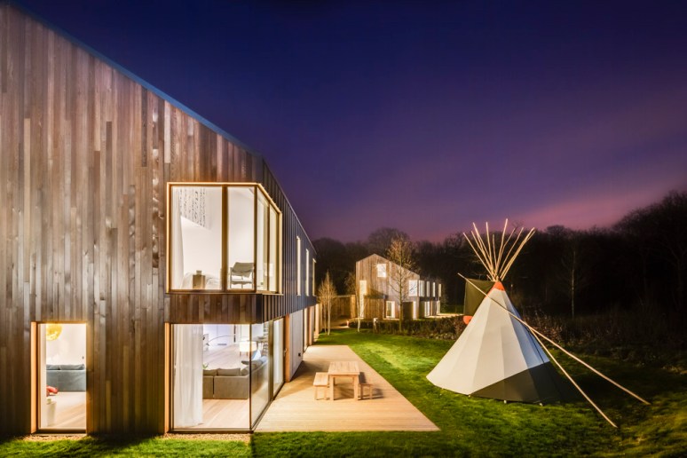 Exterior view of The Woods residential property at dusk designed by Scott Brownrigg, Bedfordshire, UK.