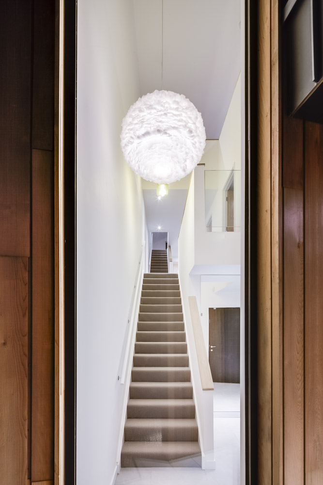 Looking up the stairs at The Woods residential property designed by Scott Brownrigg, Bedfordshire, UK.