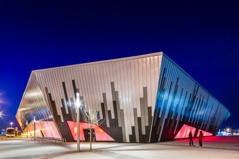 Exterior view of the Ice Arena Wales at night, designed by Scott Brownrigg, Cardiff, Wales, UK.
