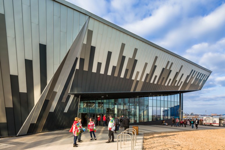 Exterior view of the entrance at the Ice Arena Wales with Red Devil supporters, designed by Scott Brownrigg, Cardiff, Wales, UK.