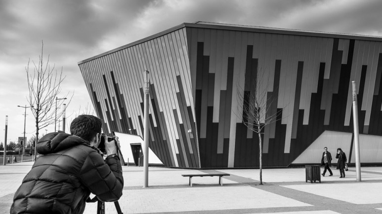 Daniel Hundven-Clements photographing the Ice Arena Wales, designed by Scott Brownrigg, Cardiff, Wales, UK.